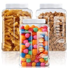 three clear containers filled with different types of pasta and candies, one is empty