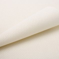 the fabric is white and has small squares on it, as well as a plain background