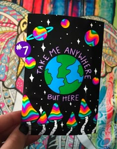 someone is holding up a card with the earth on it