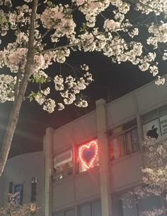 a building with a heart shaped light on it