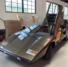 a car parked in a garage with its door open to reveal the inside of it