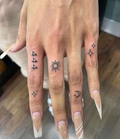 a woman's hand with tattoos on her fingers and the number 544 written in black ink