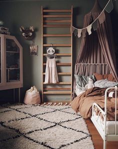 a bedroom with a bed, ladder and rug