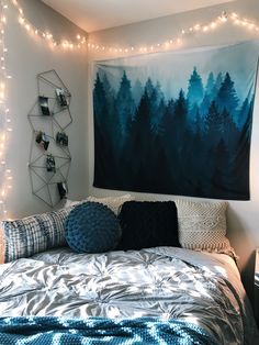 a bedroom decorated with string lights and an art work on the wall above the bed