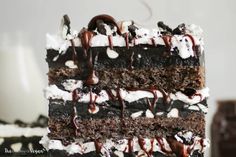 a close up of a slice of cake with chocolate and marshmallows on it