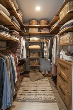 an organized closet with baskets, clothes and rugs on the floor in front of it