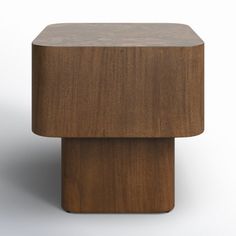 a square wooden object sitting on top of a white surface with no one around it