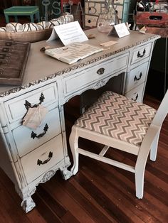 an antique desk and chair are on display