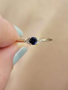 "14k gold Blue Sapphire  Ring, Art Deco Blue Gemstone Anniversary Ring, Genuine Sapphire Ring, September Birthstone Ring, White, Rose Gold  Ring Features:  * Made to Order. * Made in NYC. * Gold: Solid 14K( Also available in18K ) * Width of band: 1.3mm * Choice of Gold: Yellow Gold, White Gold, Rose Gold, or Platinum * Gem Stone: Genuine Blue Sapphire Stone & Mined Diamonds * Center stone: * Round Blue Sapphire 4mm * Weight 0.20 Ct  * Side Stones details: * 6 Round Genuine Diamonds 1.3 mm each D Gold Blue Sapphire Ring, Memory Ring, September Birthstone Ring, Art Deco Sapphire Ring, September Birthstone Rings, Ring Rosegold, Deco Blue, Blue Sapphire Ring, Ring Art Deco