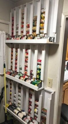 the shelves are filled with canned food and other items for storage in this pantry area