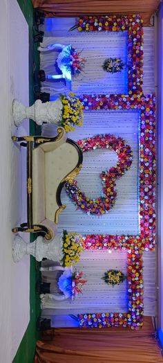 an elaborately decorated bench in the middle of a room filled with flowers and candles