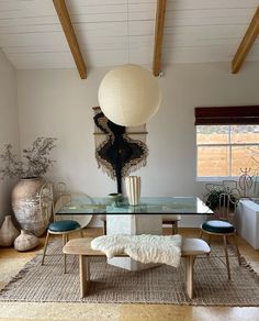 a living room with a glass table and chairs