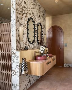 a bathroom with two sinks and mirrors on the wall