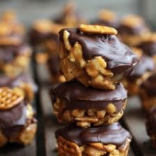 chocolate covered cookies with walnuts and pretzels stacked on top of each other