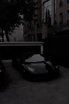 two cars parked next to each other in front of a building