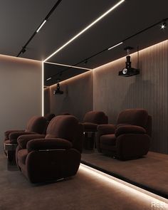 an empty theater with brown recliners and lights on the ceiling, in front of a white wall