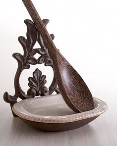 a wooden spoon sitting in a bowl on top of a table