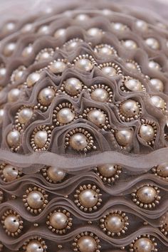 a close up view of pearls on fabric