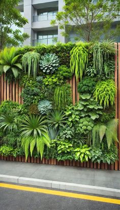 an outdoor living wall with plants and greenery on the sides, along side a street