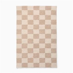 a beige and white checkered rug on a white background with the words,'home is