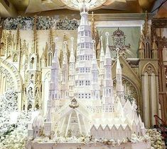 an elaborately decorated cake is displayed in front of a backdrop