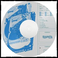 a blue and white disk drive sitting on top of a paper sheet with words underneath it