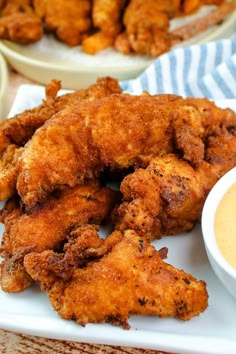 fried chicken with dipping sauce on a white plate