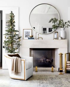 a living room with a christmas tree in the corner and decorations on the fireplace mantel