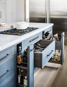 an open drawer in the middle of a kitchen counter