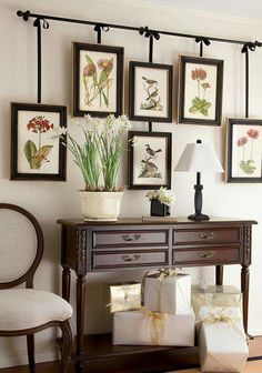 a living room filled with furniture and pictures on the wall