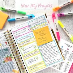 notebooks, pens and sticky notes on a table with the words hear my prayer