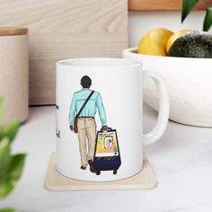 a coffee mug with a drawing of a woman carrying a luggage bag on the side