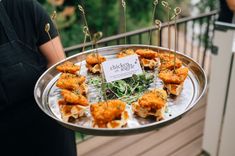 a person holding a tray with food on it