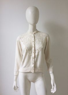 Vintage 1950s cream lace cardigan. Feels like super soft acrylic, pearl buttons, raglan sleeves, unlined, no labels. Fits like a medium. Excellent vintage condition. Please message me with any questions.  Measurements: sleeve to neck 26 bust 39 waist 32 length 20 more vintage clothing  https://www.etsy.com/shop/prizesforarla for shop previews, follow me on instagram: prizesforarla  Purchases are subject to sales tax international buyers: Please note that your order may be subject to customs char Lace Cardigan, Cream Lace, Cardigan Fashion, Vintage 1950s, Raglan Sleeve, Cardigans For Women, Sweaters & Cardigans, Sweater Outfits, Long Sleeve Blouse