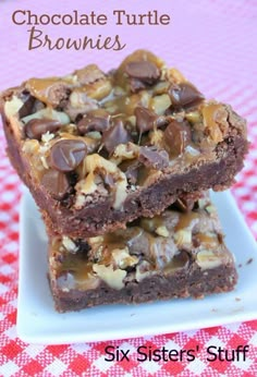 chocolate turtle brownies are stacked on top of each other with nuts and chocolate chips