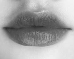 a woman's lips are shown in black and white