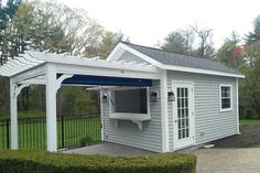 a small white house with a blue awning