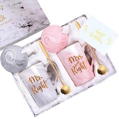 two pink and white soaps in a gift box with gold lettering on the side