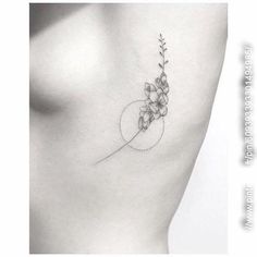 the back of a woman's neck with flowers on it and a circle in the middle