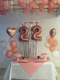 the table is set up with balloons, cake and cupcakes for an elegant 21st birthday party