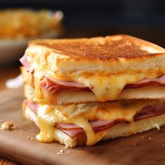 a grilled cheese and ham sandwich on a cutting board