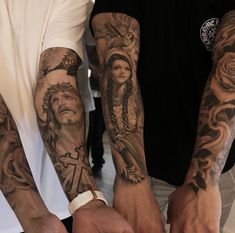 two men holding hands with tattoos on them