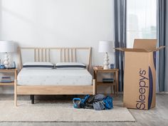 a bedroom with a bed, nightstands and a moving box in the foreground