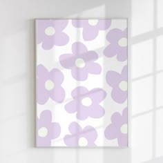 a white wall with a purple flower pattern on it