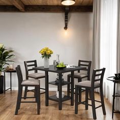 a dining room table and chairs with flowers on top