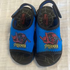 New Without Tags Spider-Man Blue Sandals Feature Spider-Man On Top Cushioned Interior, Foam Exterior & Rubber Non Slip Textured Soles Open Toe Velcro Closed A Great Summer Shoe For The Pool Beach And Casual Walking One Size Fits Most Preschoolers Or Toddlers; The Size Is Not Indicated So Please See Measurements Below For The Best Fit Length 7 1/4 Inches Width 3 Inches New Without Tags; Would Make A Great Gift Smoke-Free Business Playful Blue Adjustable Sandals, Playful Adjustable Blue Sandals, Casual Slide Sandals For Playtime, Adjustable Blue Sandals For Playtime, Casual Non-slip Eva Foam Sandals, Casual Non-slip Sandals With Eva Foam, Summer Eva Foam Closed Toe Sandals, Casual Non-slip Sandals For School, Blue Adjustable Non-slip Sandals