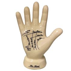 a ceramic hand that has writing on it