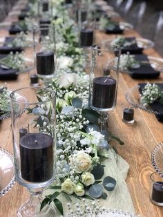 a long table with candles and flowers on it