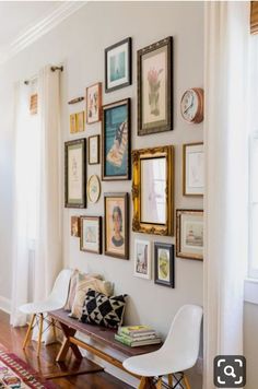 a room with pictures on the wall and a bench