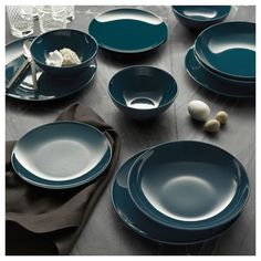 a table topped with blue plates and bowls